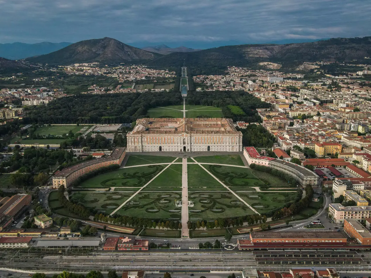 Stunning aerial photograph of the Royal Palace of Caserta and its expansive gardens.